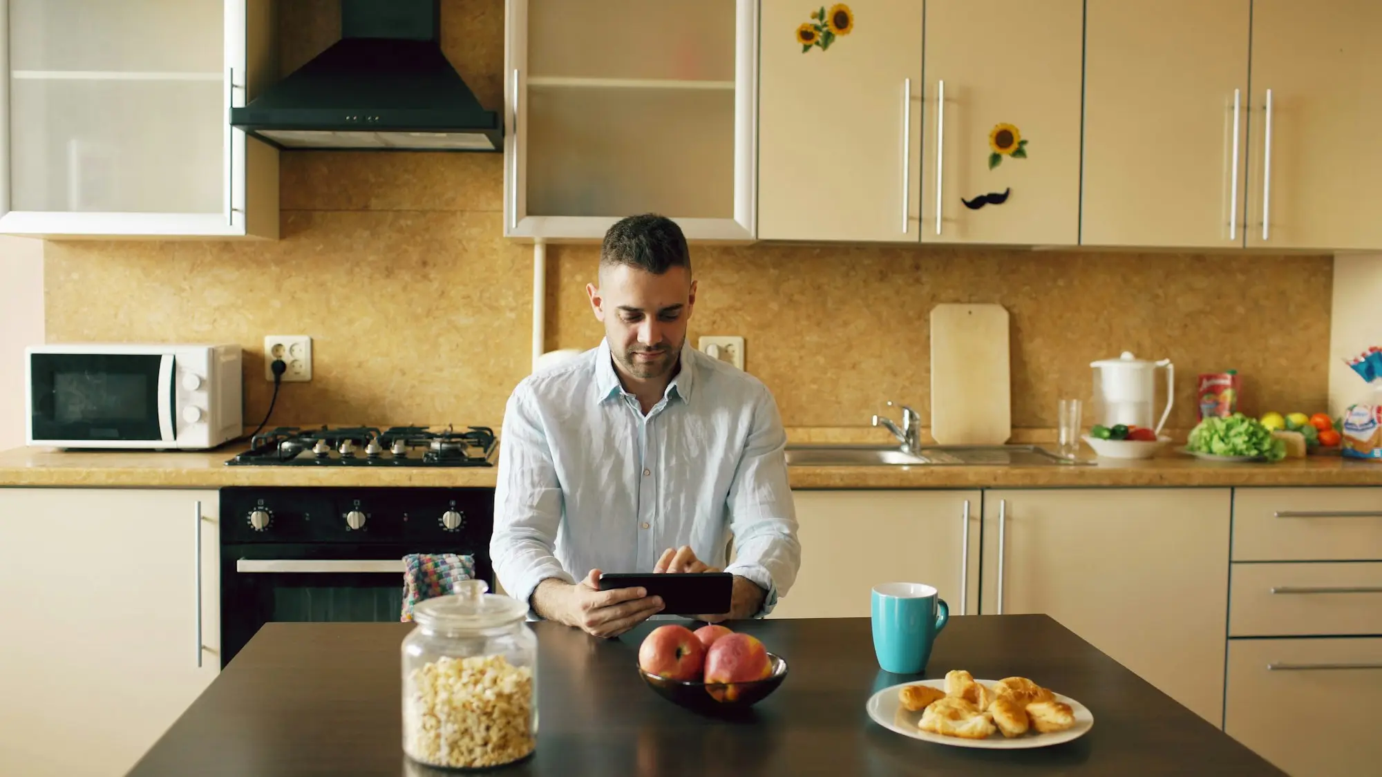 Man using a tablet in a modern kitchen