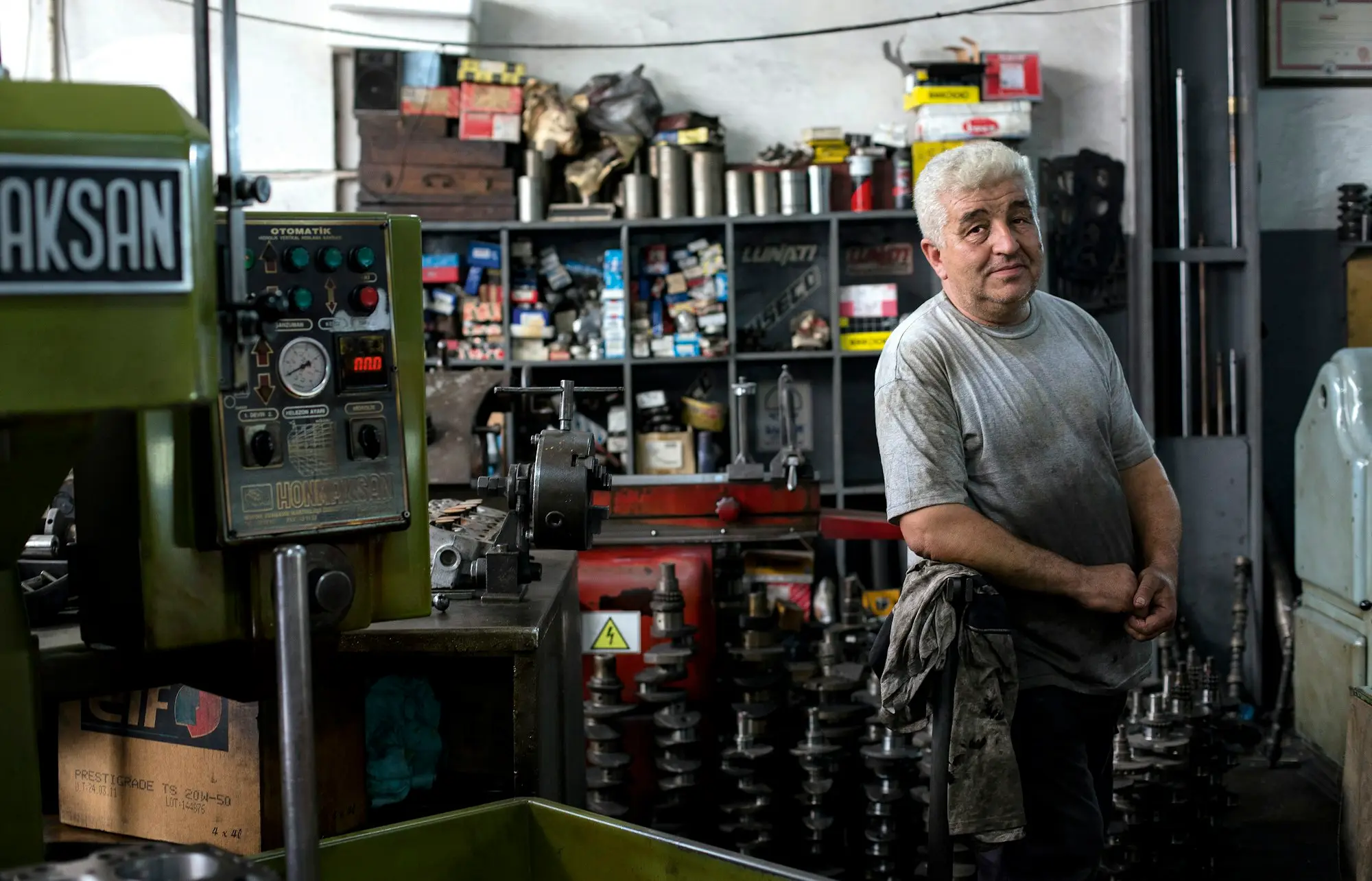 Workshop owner beside his machinery